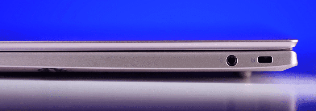 Right side of Acer laptop showing a headphone jack and Kensington lock slot with a blue background.
