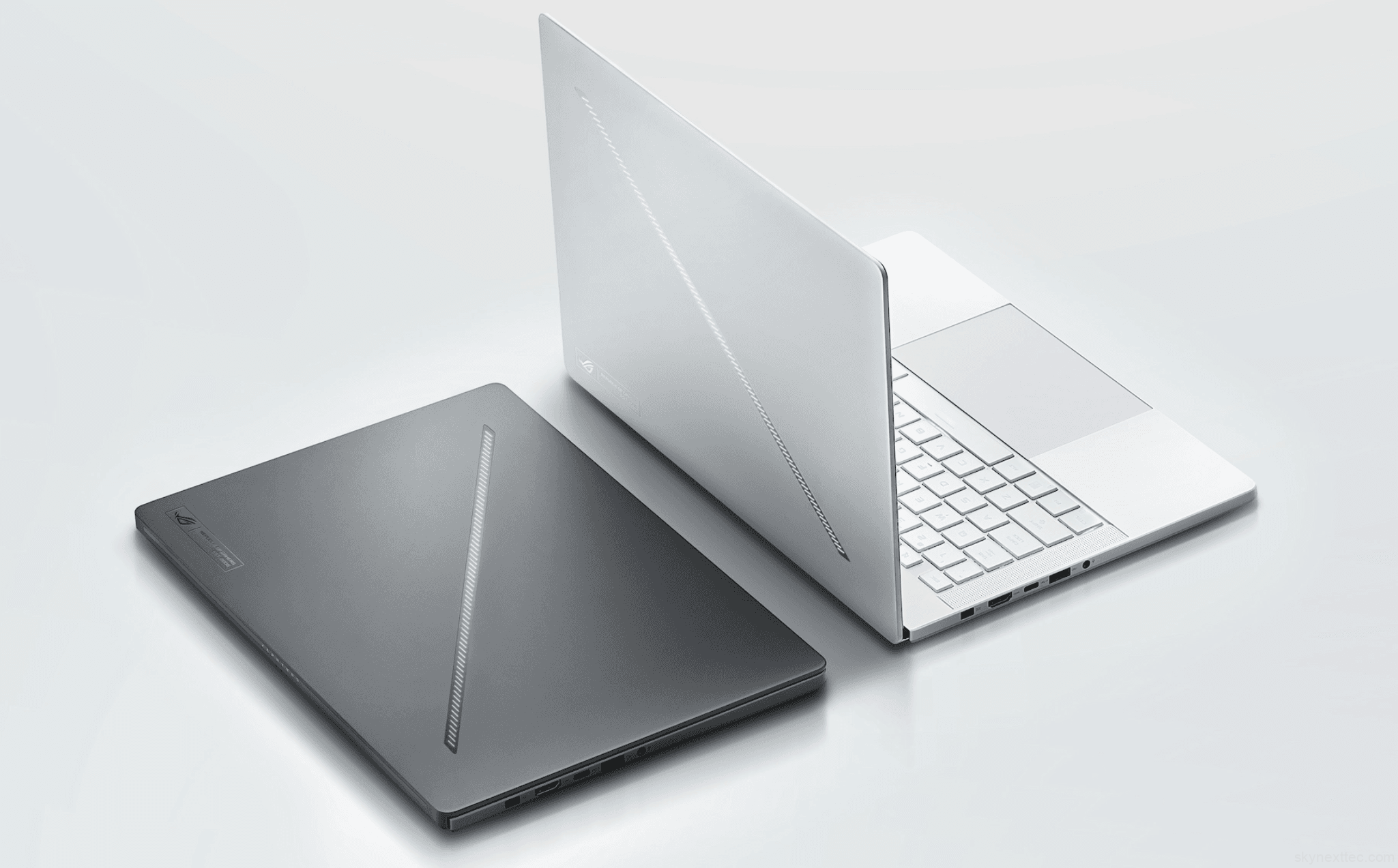 Two Asus ROG Zephyrus G14 laptops, one in Eclipse Gray and one in Platinum White, displayed on a clean white surface with the Slash Lighting LED strip visible on the lid.